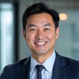 Portrait of Dr. Aaron Chen, a distinguished male wellness expert.