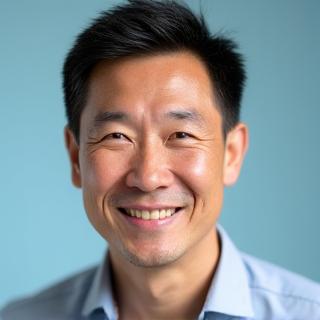 Professional headshot of Liam Chen, a compassionate and energetic male wellness coach.