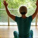 Person performing a gentle stretch or a low-impact exercise, illustrating improved mobility.