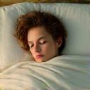 Person peacefully sleeping under a soft blanket, indicating restful sleep.
