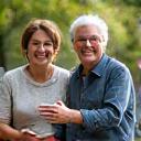 Two diverse adults smiling and giving a high-five, symbolizing a supportive buddy system.