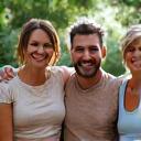 A diverse small group of adults actively participating in a light wellness activity together, such as a group stretch or a walking club, showing camaraderie.